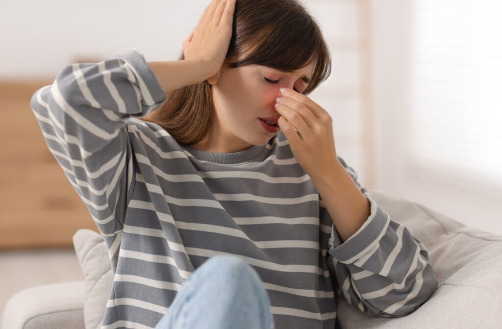 Someone with a sinus infection also clutches their head due to a related headache.