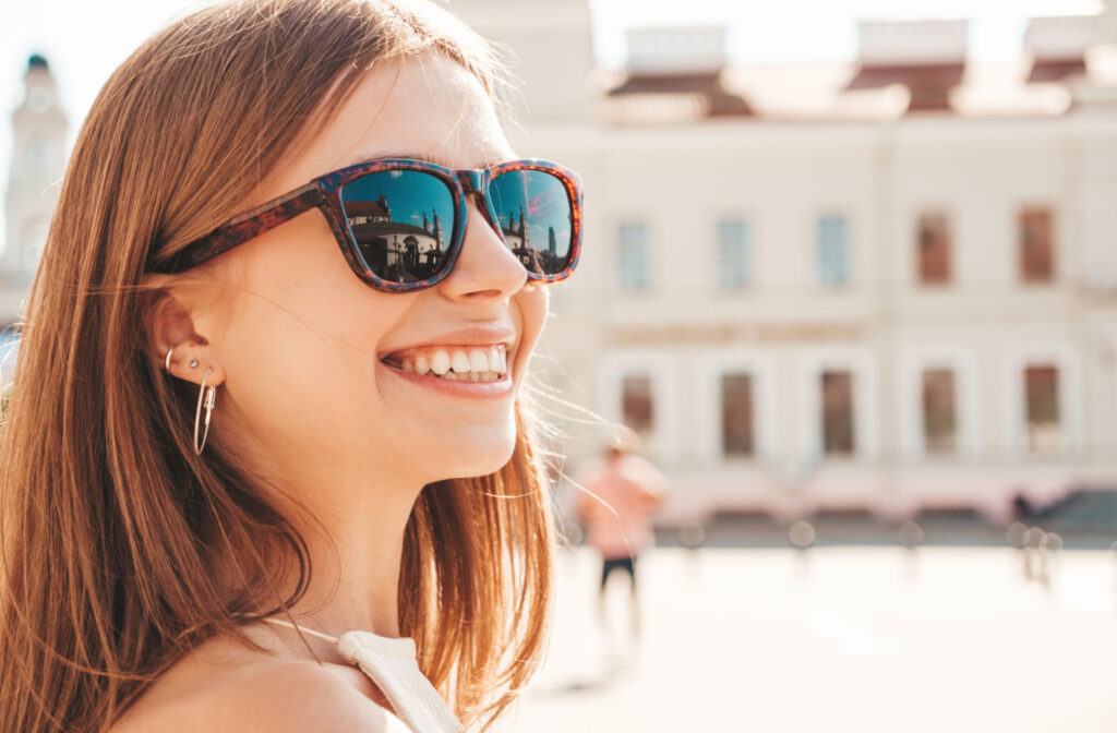 A person wearing sunglasses with prescription lenses so they can see clearly while protecting their vision